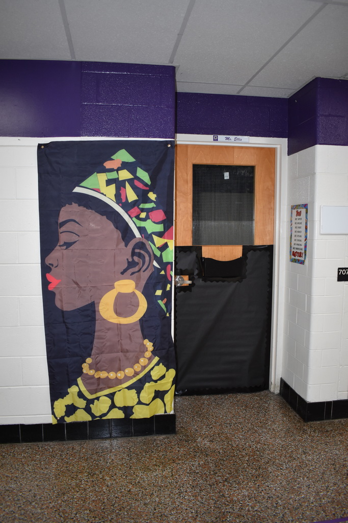 A door decorated for black history month with a woman in traditional African clothing.