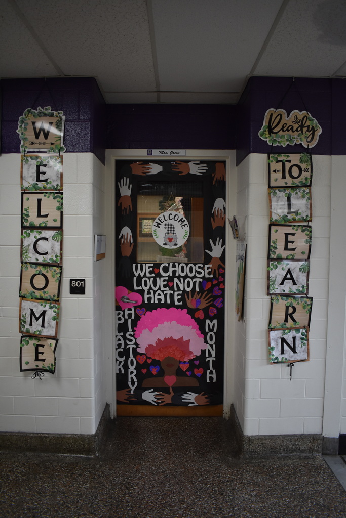 A black door decorated for Black history month that says We choose Love not Hate.