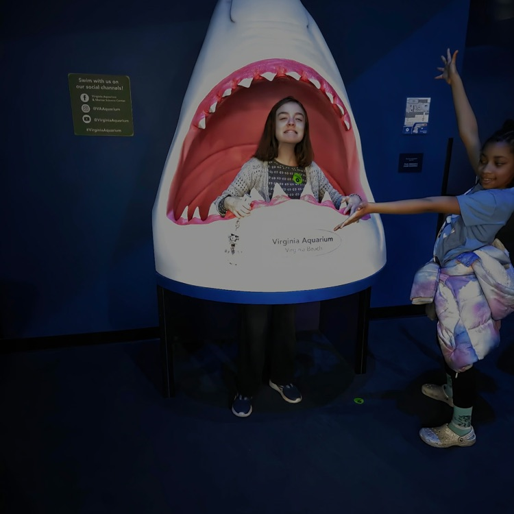 student in shark statue