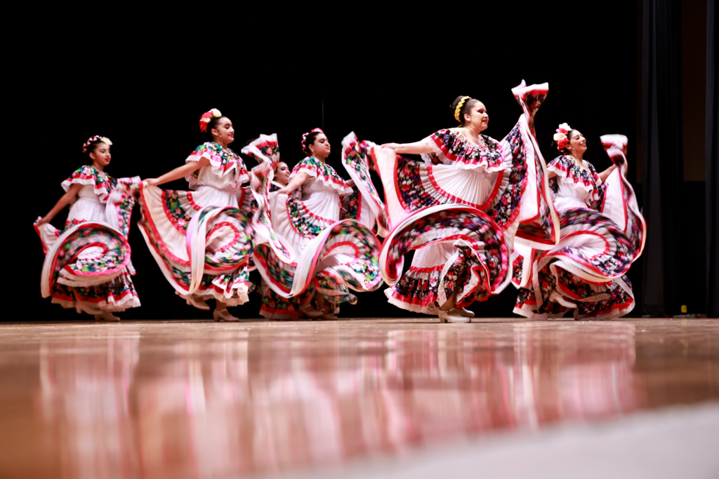 Flamenco dancers on stage twirling skirts