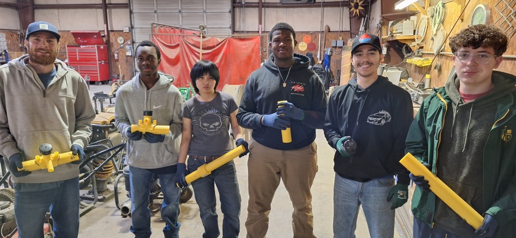 students and mentors with pipes