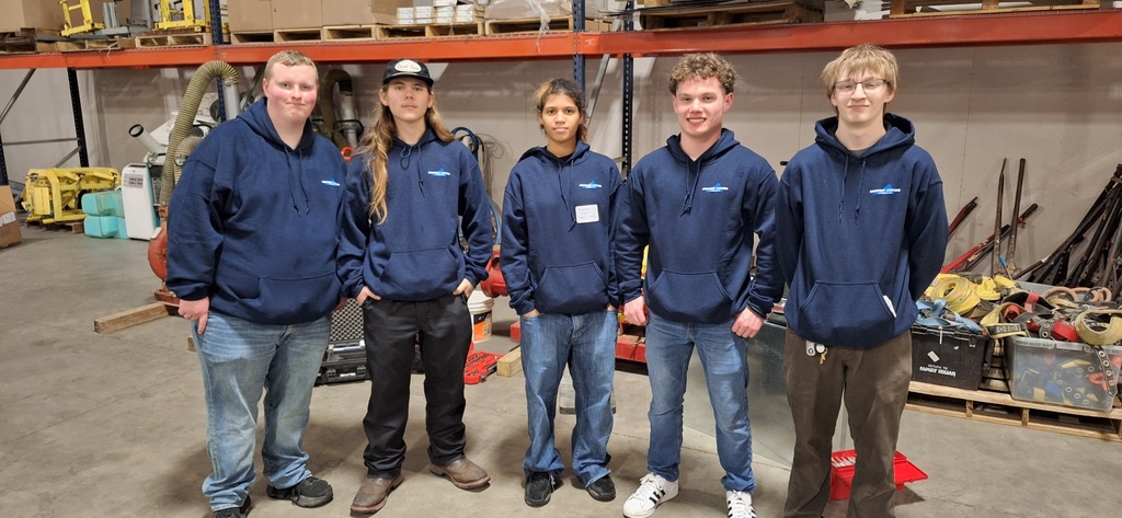 students in warehouse smiling