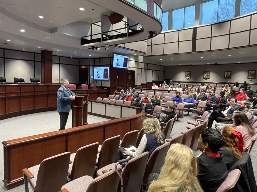 Dr. cotton in city hall at podium discusisng Job Shadowing