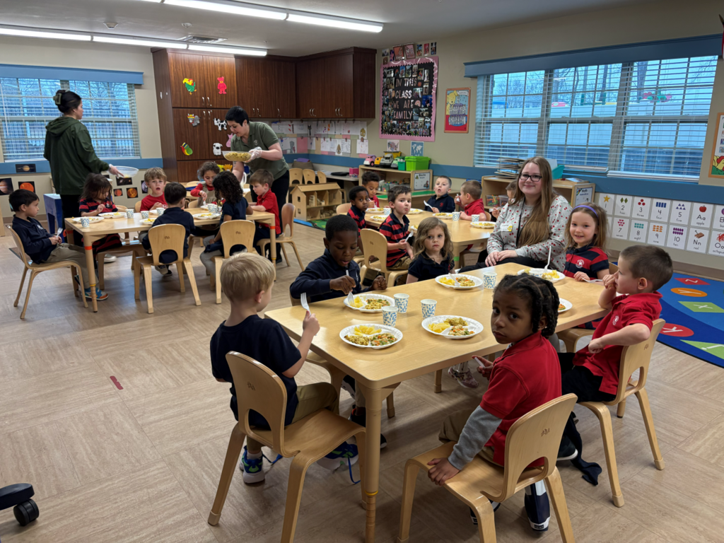 student eating lunch with preschoolers