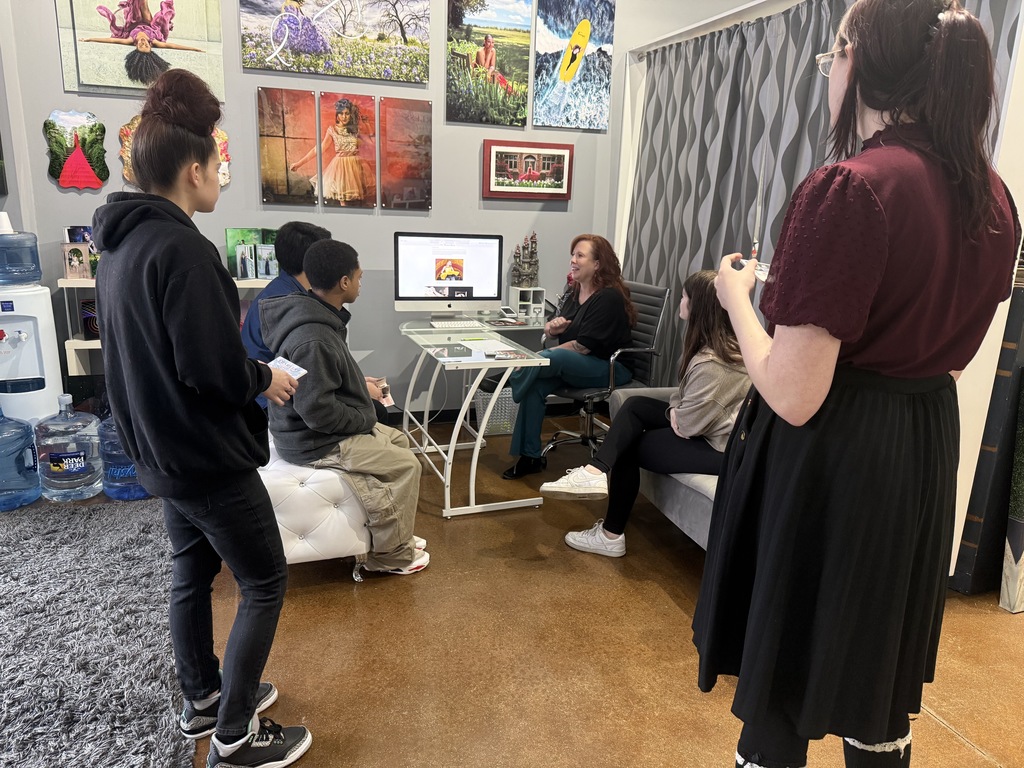 mentor artist showing students designs