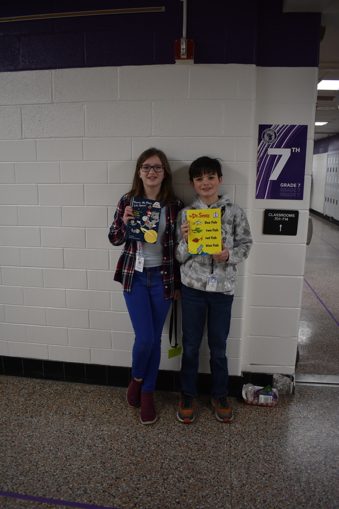 Two students carrying their favorite Dr. Seuss book