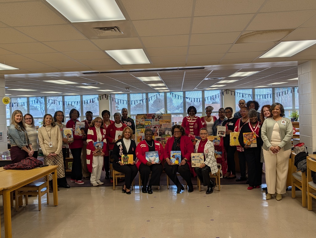 sorority members of delta sigma theta and the admin, librarian, and academic coaches smiling