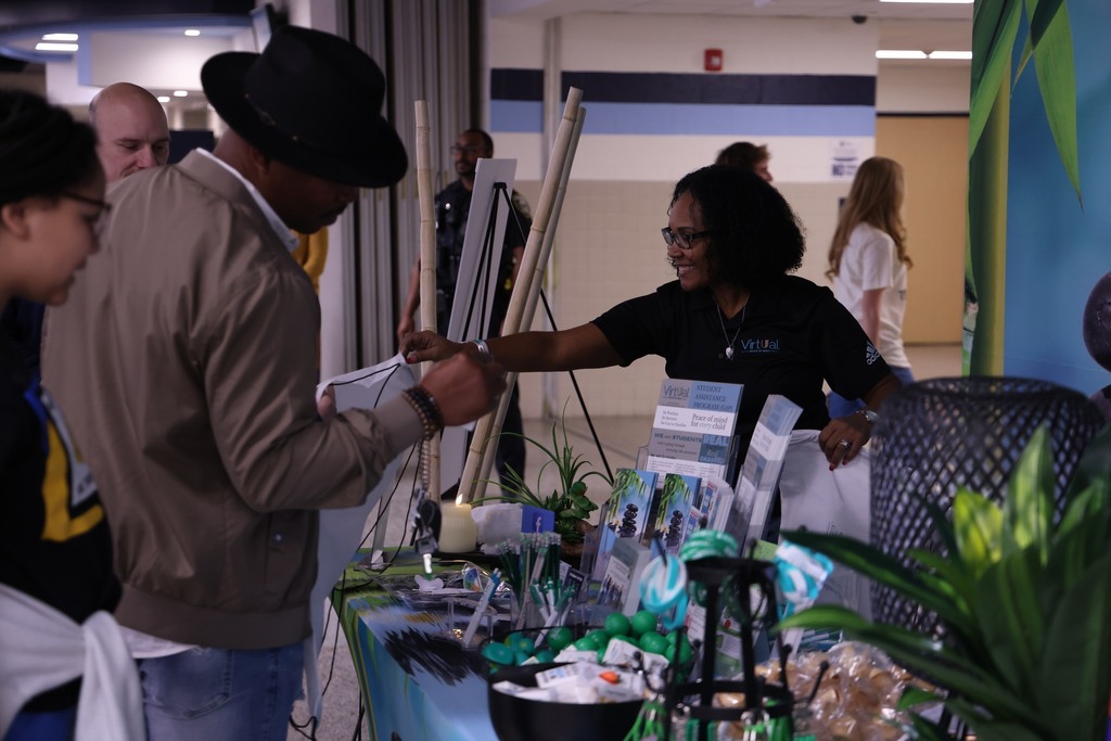 Someone handout out resources at a table.