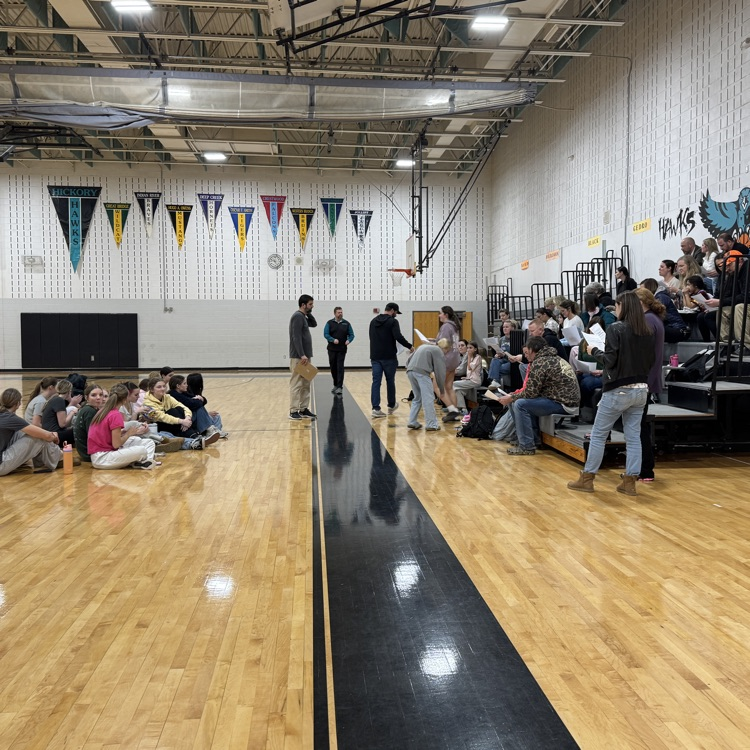 students and parents in team meeting with coach