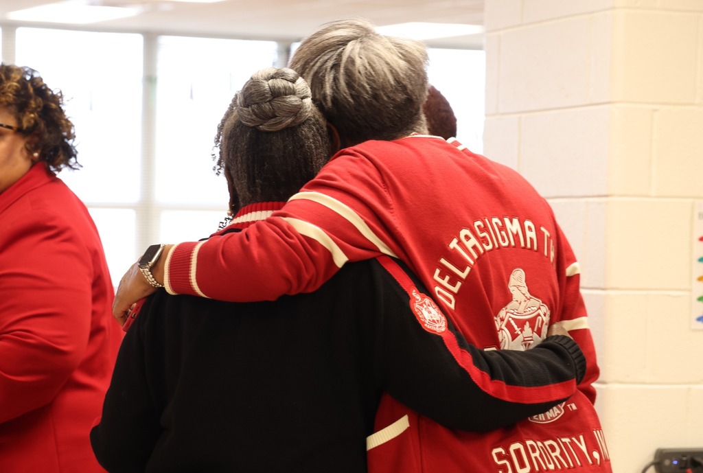 two sorority sisters hugging.