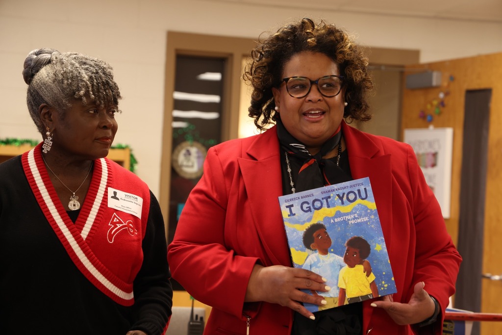 President of sorority holding book and talking