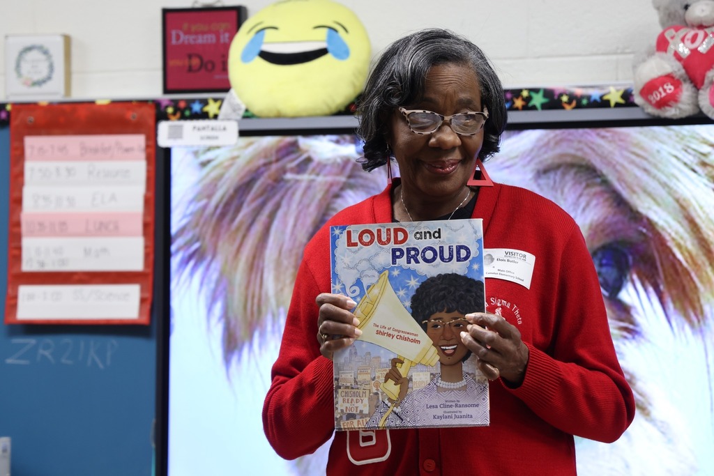 medium shot of sorority sister holding book Loud and Proud