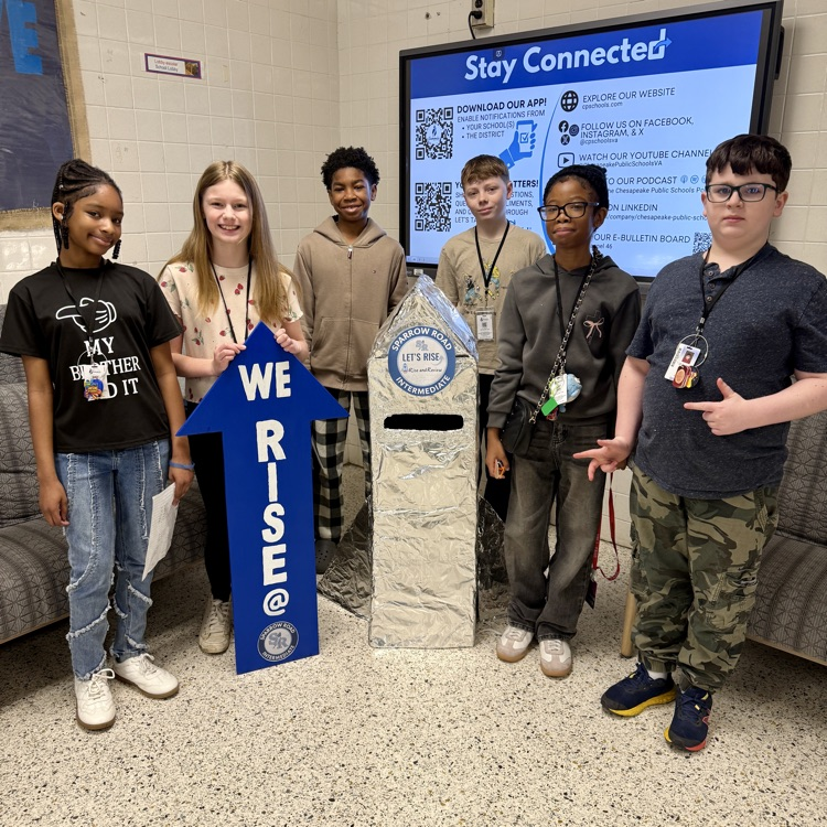 Students with the We RISE arrow and the RISE and review rocket