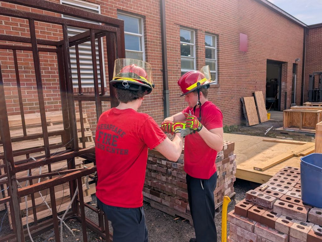 Firefighting students practicing forcible entry