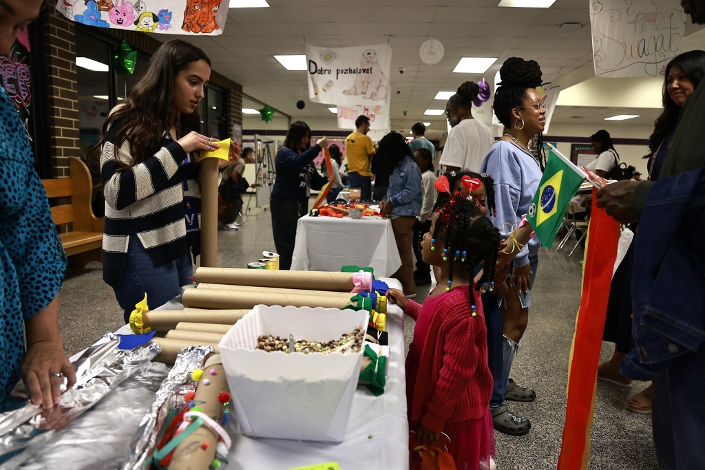 little girl asking for help making a rain stick