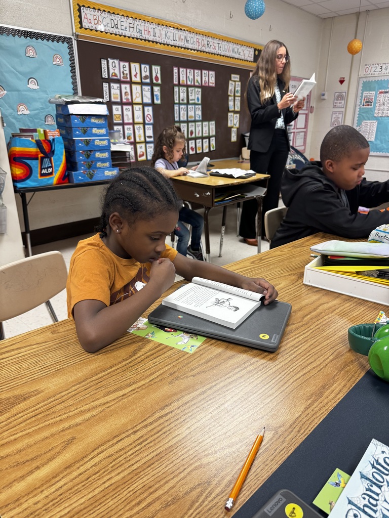 students & staff reading charlottes web