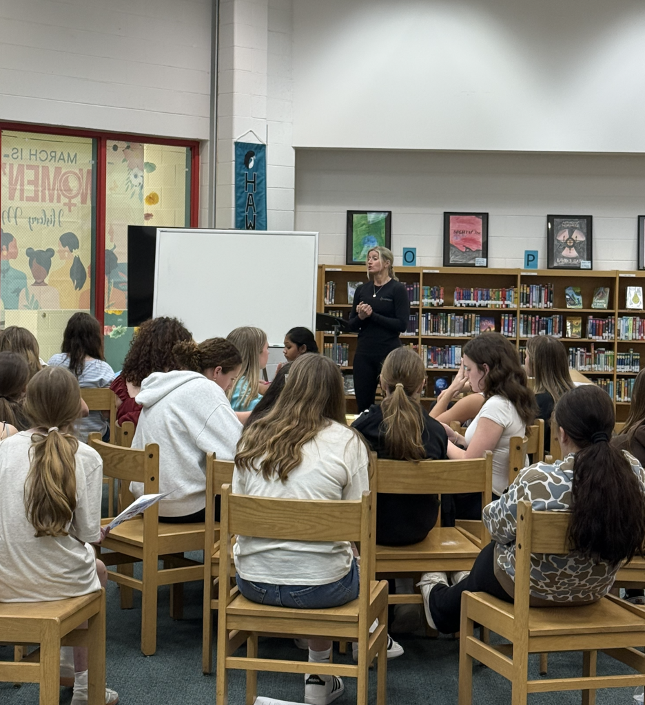 Field Hockey members listening to guest speaker