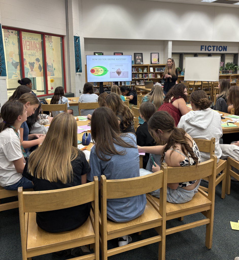 Field Hockey members listening to guest speaker