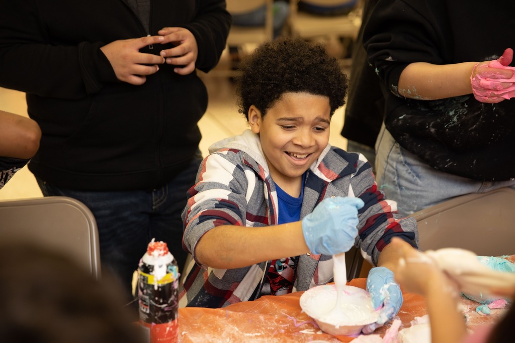 Boy stirring goup with grossed out face