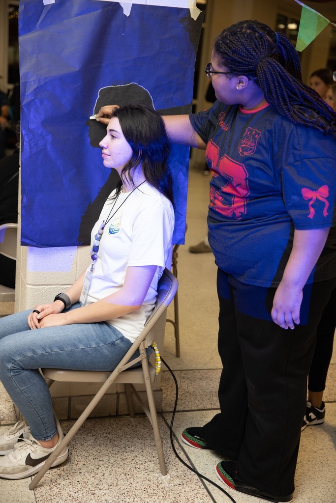 student outlining facial profile of another student