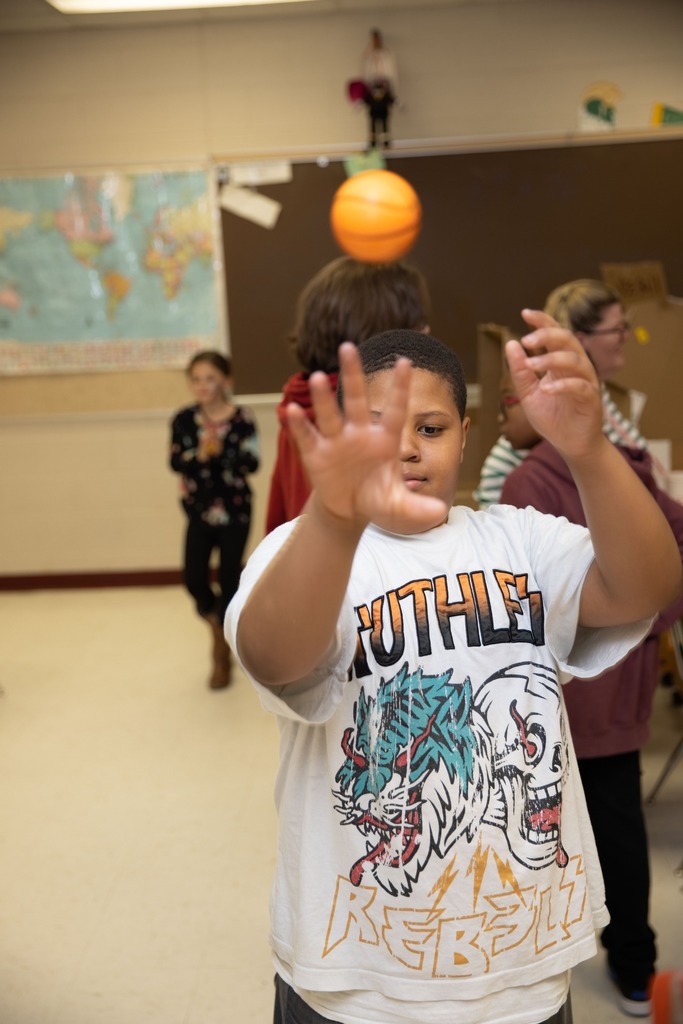 student throwing basketball