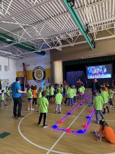 First graders and Mr. Mason dancing at DanceFit!