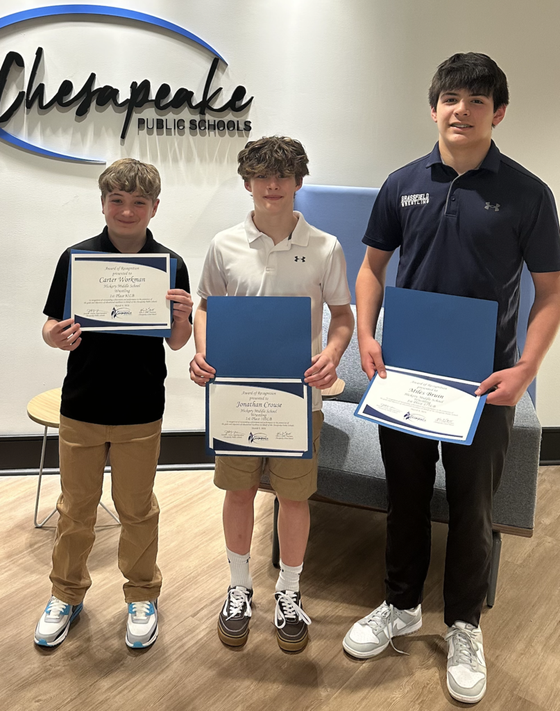 wrestlers with certificates from the school board recognition