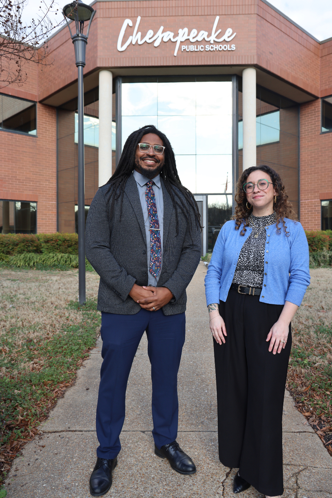 Orion and Taylor standing in from of the School Administration Building