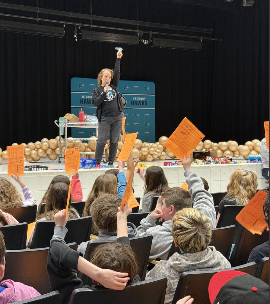 students in the auditorium for their team auction