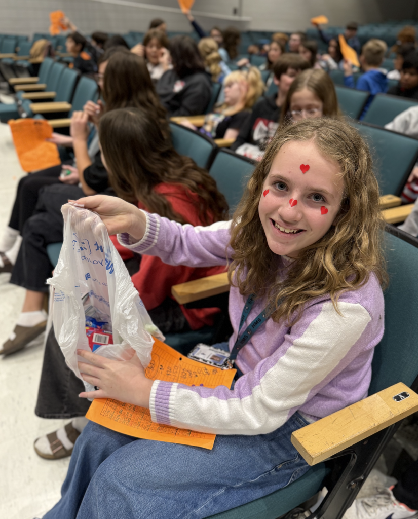 students in the auditorium for their team auction