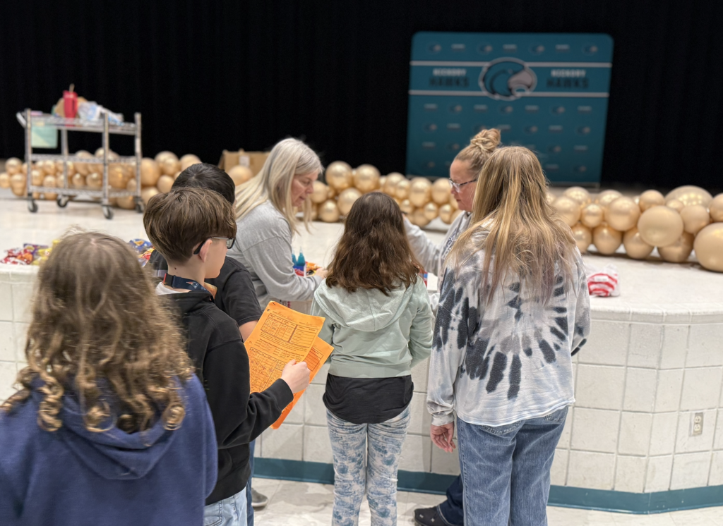 students in the auditorium for their team auction