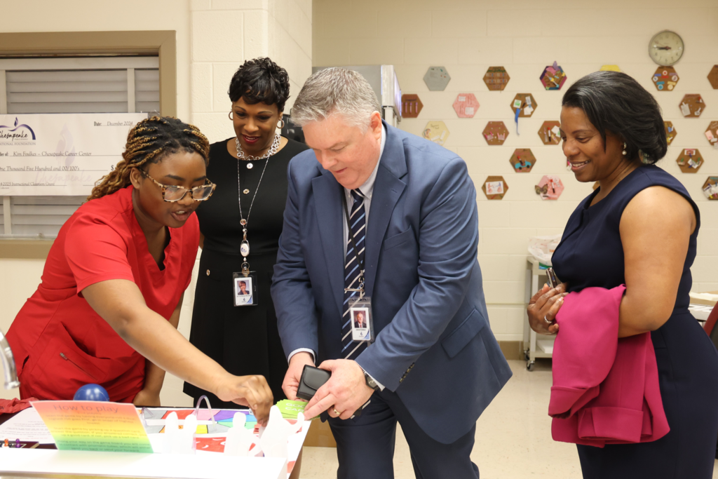 Dr. Cotton, CCC student, and Dr. Windham playing board game at CCC