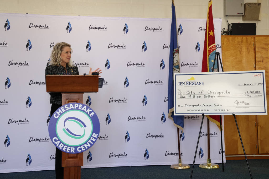 Kiggins presenting the check from podium