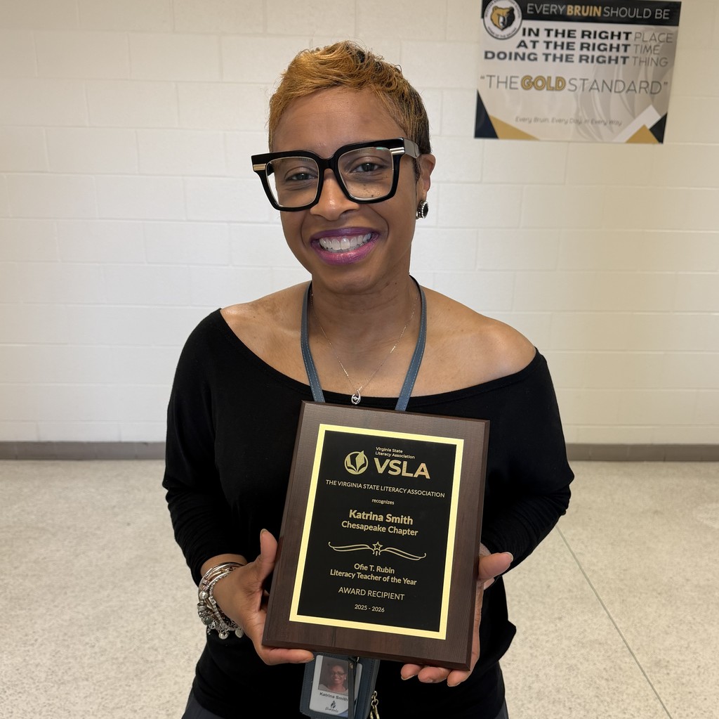 Mrs. Katrina Smith holding VSLA plaque