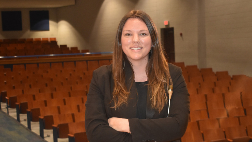 Emily Wolcott in OSHS auditorium smiling for camera