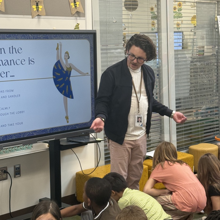 Mr swafford giving a lesson to the second grade bees on Ballet etiquette for their field trip to see Alice in Wonderland 