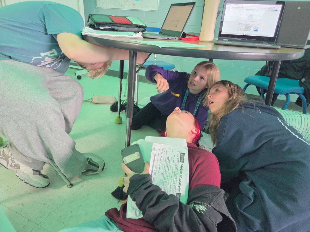 students working on a scavenger hunt in math class