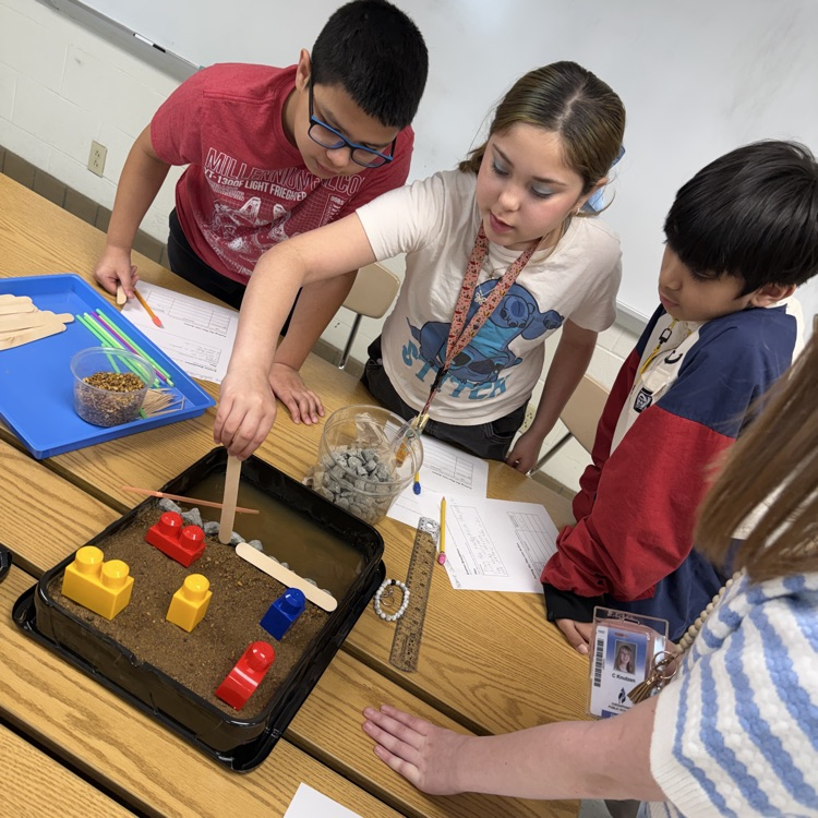 students working together on their erosion models