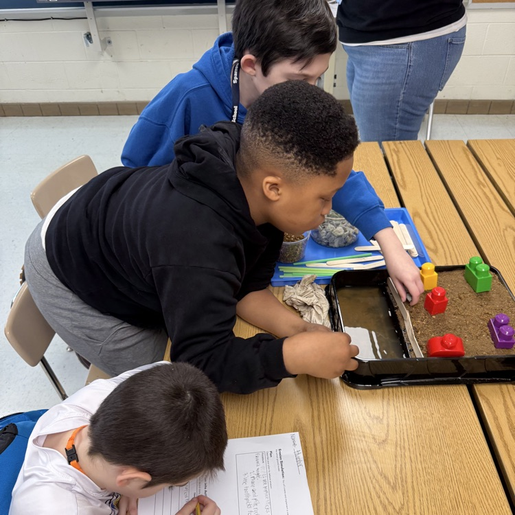 students working together on their erosion models