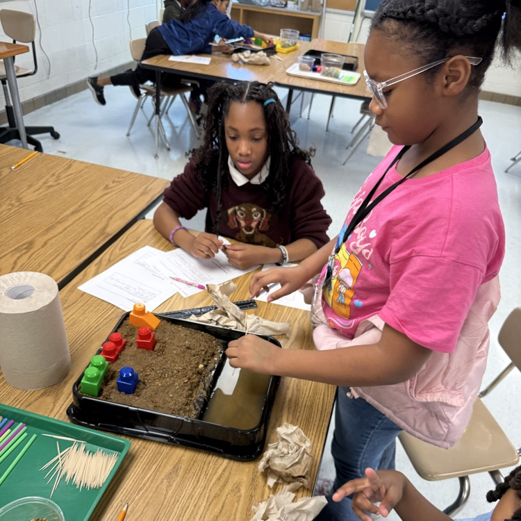 students working together on their erosion models