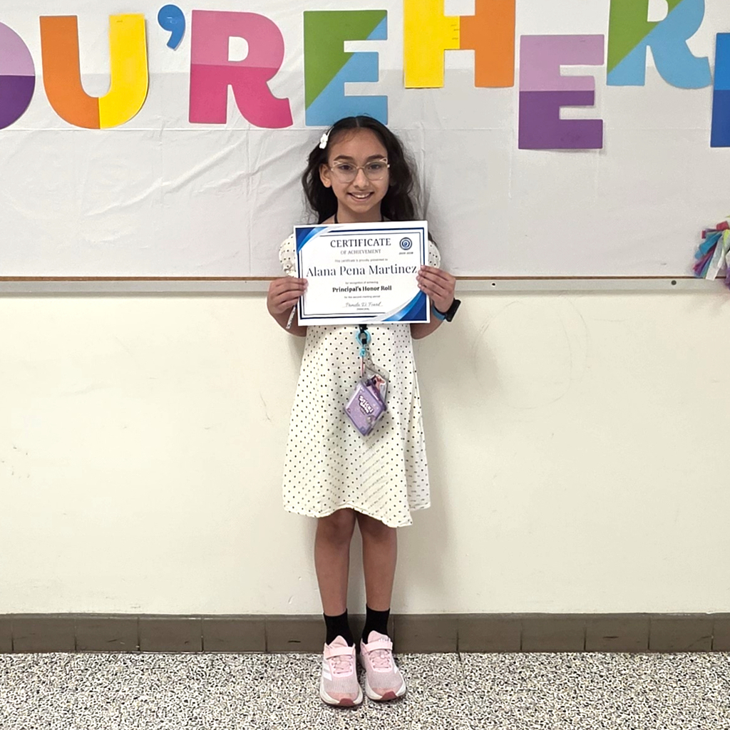 3rd grade students posing to show her honor roll certificate