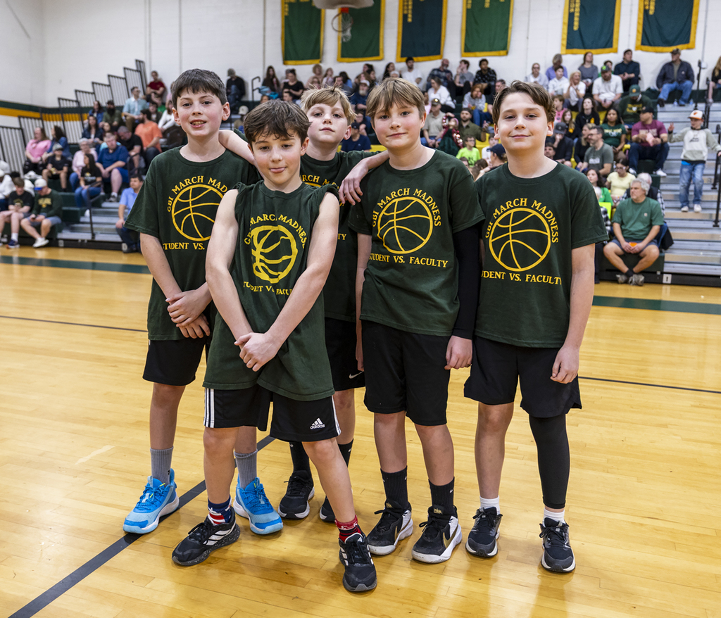 Boys posing in their basketball tshirts