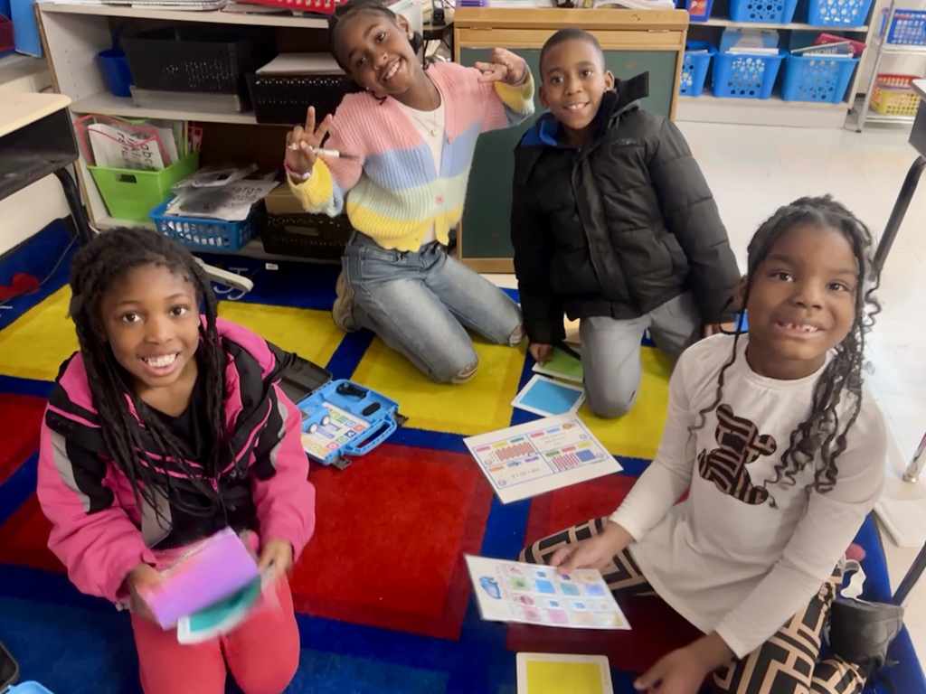 2nd graders practicing place value with robots