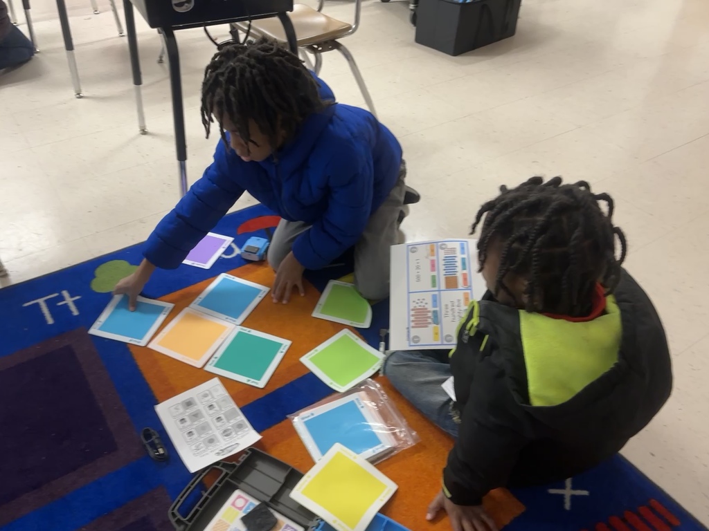 2nd graders practicing place value with robots