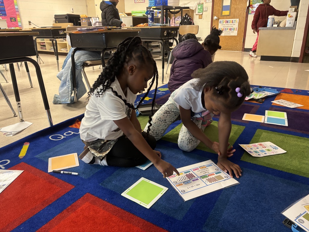 2nd graders practicing place value with robots