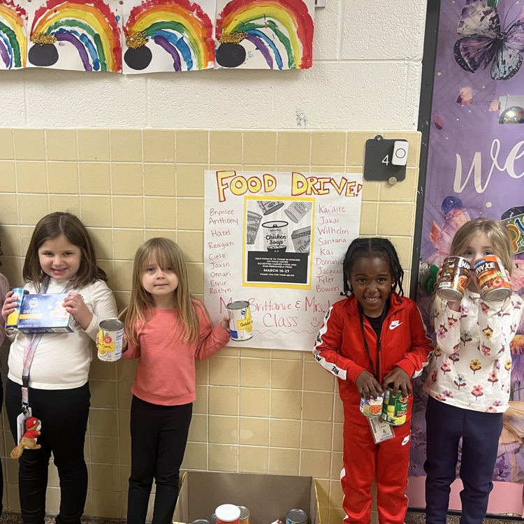 Preschool students excited about their food drive donations.