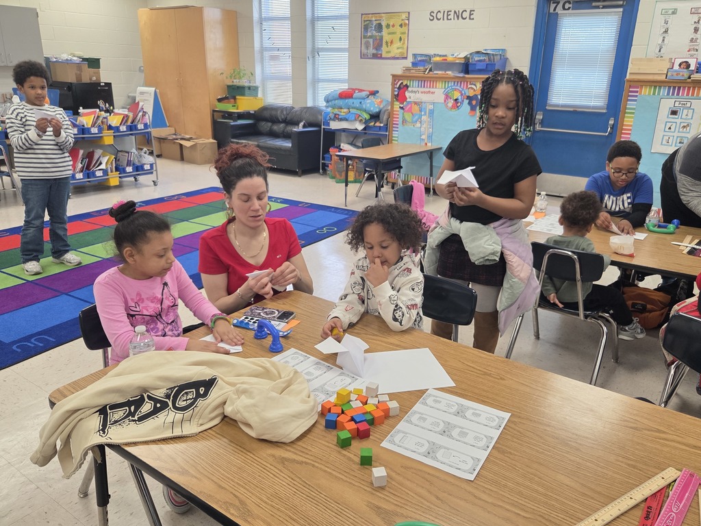 Students making paper airplanes.
