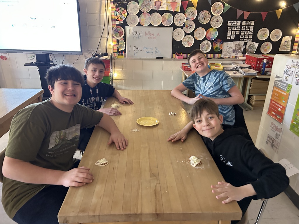 Smiling students happily participating in a hands-on student taught lesson 