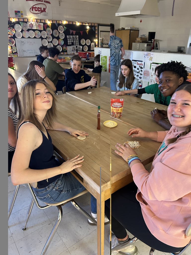 Smiling students happily participating in a hands-on student taught lesson 