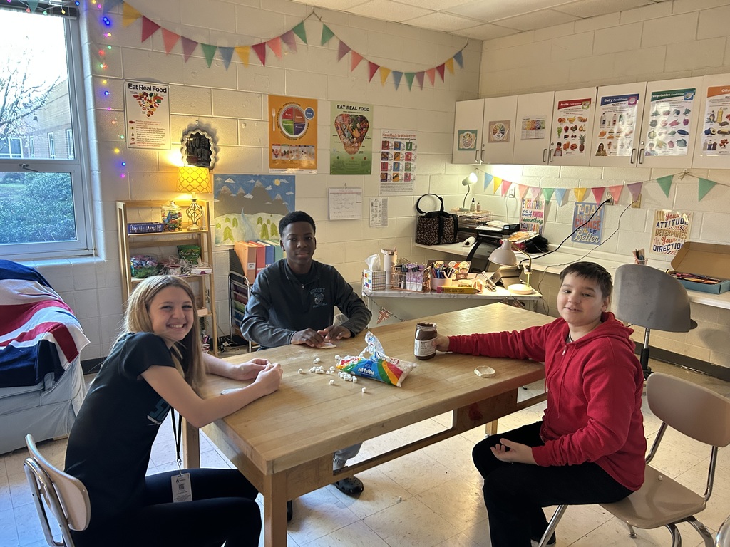 Smiling students happily participating in a hands-on student taught lesson 